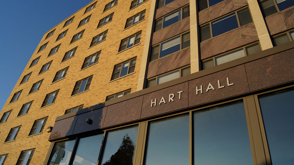 Blue sky reflects in Hart Hall windows